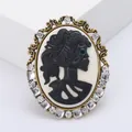 Vintage cameo brooch with black skull portrait and crystal embellishments on bronze frame - Gold