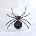 Vintage spider brooch with black rhinestones and red eyes on white geometric stand - Black