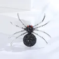 Detailed macro of vintage crystal spider brooch with black stones and red crystal eyes - Silver