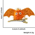Close-up of orange glitter bat hair clip showing 8.2cm width and 4cm height dimensions - Orange