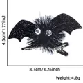 Glittery black bat hair clip with plush pompom and size measurements for Halloween party - Black