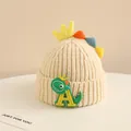 Detailed knit texture of beige winter baby hat with cute 3D crown and dinosaur patch - 2-6 Years Old / Beige