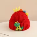 Detail of red knit hat showing soft wool texture and colorful 3D dinosaur spikes - 2-6 Years Old / Red