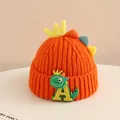 Detail of orange knitted winter hat for children featuring a 3D dinosaur fin design - 2-6 Years Old / Orange