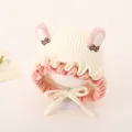 Detail of baby knit hat with pink bunny ears and soft white yarn texture closeup - Rabbit Ears Style / Light Beige