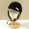 Detail of winter trapper hat with warm brown faux fur lining and adjustable chin strap - Kids / Black