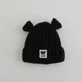Detail of black knit baby beanie featuring cute round ears and a cartoon bear patch - Baby 2-7 Years / Black