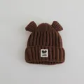 Detail of dark brown knit baby hat featuring cute ears and Fashion GOOD woven label - Baby 2-7 Years / Dark Coffee