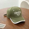 Detail of olive green cotton baseball cap with Hello! smiley face embroidery on a wood table - Kids 3-8Y (48-53CM) / Army Green