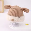 Detailed view of baby knit hat with brown ribbed texture and soft white faux fur trim - 48-50cm (Fits 2-4 Years) / Khaki