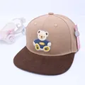 Close-up of kids hip-hop cap featuring 3D cartoon bear patch and brown flat brim - Kids approx 3-10 years / Beige & Brown
