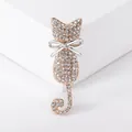 Exquisite cat brooch in rose gold with shimmering white rhinestones and a silver bow accent - Gold