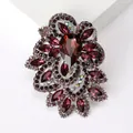 Detailed macro of vintage crystal brooch with garnet red gems and silver alloy setting - Purple