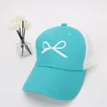 Detail of mint green mesh baseball cap with white embroidered bow and breathable back - Kids Size / Lake Blue