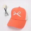 Detailed view of orange mesh baseball cap featuring white bow embroidery and breathable fabric - Kids Size / Orange