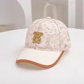 Detailed macro of kids mesh baseball cap featuring cute embroidered bear and mesh texture - Adjustable Kids Size / Beige