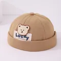 Khaki cotton kids skull cap featuring cute plush bear patch and Lucky label detail - Bear Patch Lucky Label (Pattern 2) / Khaki