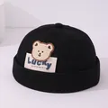 Black cotton docker hat for kids featuring a plush bear patch and Lucky label - Bear Patch Lucky Label (Pattern 2) / Black