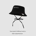 Detail of kids black bucket hat with white RANHSR embroidery and adjustable chin strap - 48-50cm / Black