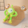 Detail of khaki corduroy kids baseball cap with a green suction cup robot toy - Khaki Robot Style