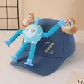Detail view of blue baseball cap with gold 'Z' embroidery and detachable blue robot toy - Blue Robot Style