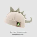 Beige corduroy dinosaur melon cap for kids with plush green fins and cute cartoon patch - Baby Size / Beige