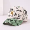 Kids hip hop baseball cap with graffiti prints and green brim featuring K-letter patch - Kids 2-6 Years 48-52CM / Beige