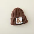 Brown knitted winter beanie for kids with a warm ribbed texture and teddy bear patch - 2-7 Years (Elastic) / Dark Coffee