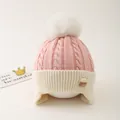 Detail of pink knit baby hat featuring plush white pompom and soft fleece earflaps - One Size / Pink