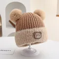 Winter knit baby hat with dual pom-poms and cute bear badge in brown and cream colors - Rubber Bear Badge Style (Style 3) / Caramel color