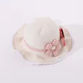 Detail of baby sun hat with lace trim, pink ribbon and flower on soft cotton fabric - Toddler One Size / Beige