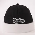 Detail of black cotton miki hat featuring blue and white Barton 3VF embroidery patches - One Size / Black