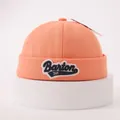 Close-up of orange cotton docker hat with Barton 3VF embroidery on white stand - One Size / Orange