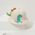 Detailed embroidery of a cartoon dinosaur on a beige cotton bucket hat for children - Beige