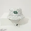 Detail of white kids sun hat with black dinosaur prints and LOVE YOU patch - Toddler 1-4 Years 47-50CM / Green