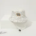 Detail of baby bucket hat featuring dinosaur print and LOVE YOU patch with chin strap - Toddler 1-4 Years 47-50CM / Yellow