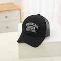 Close-up of Brooklyn embroidery on breathable black mesh baseball cap for kids - 48-52cm / Black