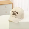 Detailed close-up of beige mesh baseball cap with Brooklyn New York embroidery - 48-52cm / Beige