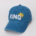 Detail of blue kids baseball cap featuring white KING embroidery and a golden crown - Kids 48-53CM / Lake Blue