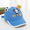 Close-up of blue kids baseball cap with panda, football, and smiley face decorations - Blue