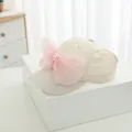 Detail of cream kids sun hat featuring a large pink organza bow and pearl ornament - Kids Size / Beige