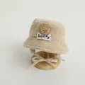 Detail of winter sherpa bucket hat featuring a brown bear patch and warm ear flaps - 48-52cm / Beige