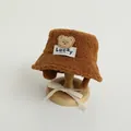 Detailed view of brown plush teddy bear bucket hat with Lucky label and chin straps - 48-52cm / Dark Coffee
