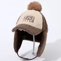 Detailed close-up of winter earmuff hat with lamb fleece and Angry Otter embroidery - Coffee