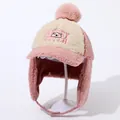 Detail view of pink fleece lining and soft sherpa texture on a child's winter earflap hat - Pink