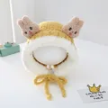 Close-up of plush rabbit winter hat with fluffy ears and embroidery for toddlers - Yellow