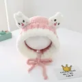 Detailed view of pink plush rabbit hat with ears and chin strap for toddlers - Pink