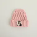 Pink knit beanie for kids featuring a large H letter patch and small smiley face - Kids 2-7 Years / Pink