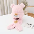Detailed view of pink plush winter hat and scarf set with Lucky bear emblem - Pink