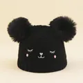 Infant winter knit beanie in black featuring cute double pom-poms and cat face embroidery - Black / Head Circumference 46-50cm (2-6 Years)
